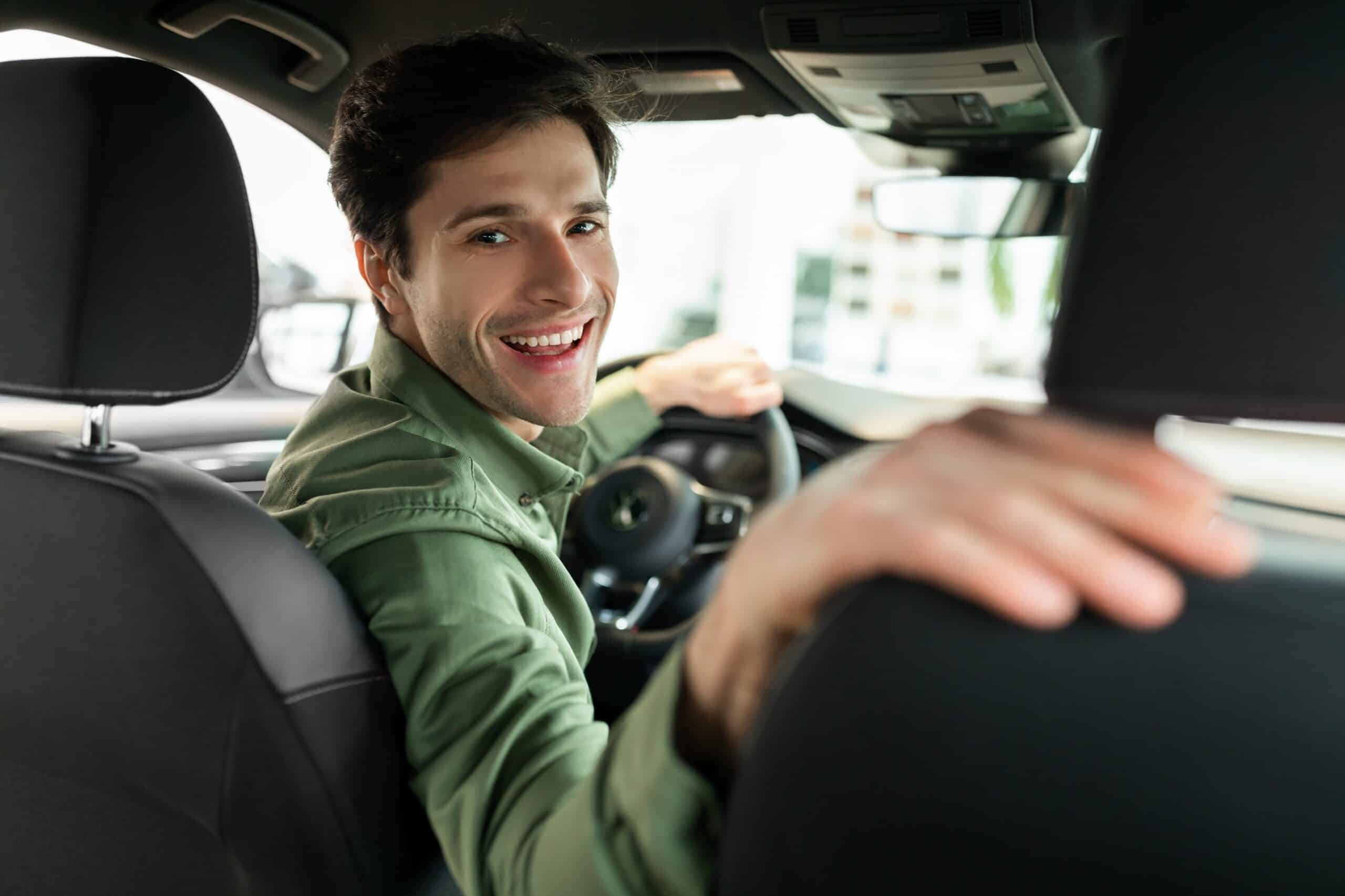 Cheerful,Young,Man,Driving,New,Automobile,After,Purchase,,Sitting,In